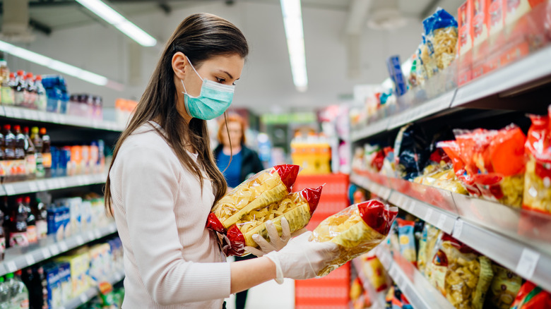 Grocery shopper checking expiration date