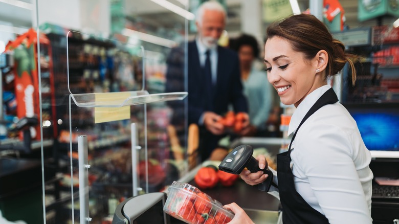 Smiling supermarket cashier 