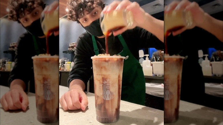 Barista pouring espresso into Marble macchiato