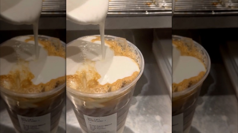 Pouring Vanilla Sweet Cream Cold Foam on a macchiato