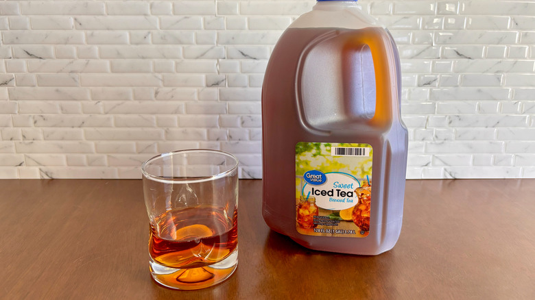 Glass of sweet tea next to Great Value gallon of sweet tea