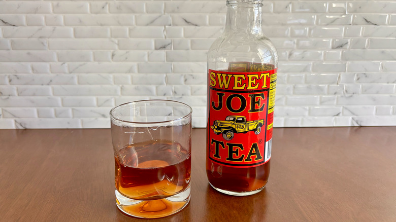 Glass of sweet tea and Joe Tea bottle on table