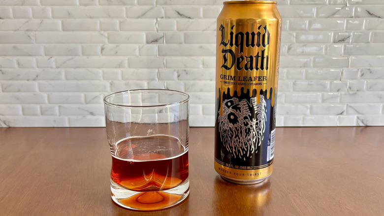 Glass of sweet tea with Liquid Death tea can on table