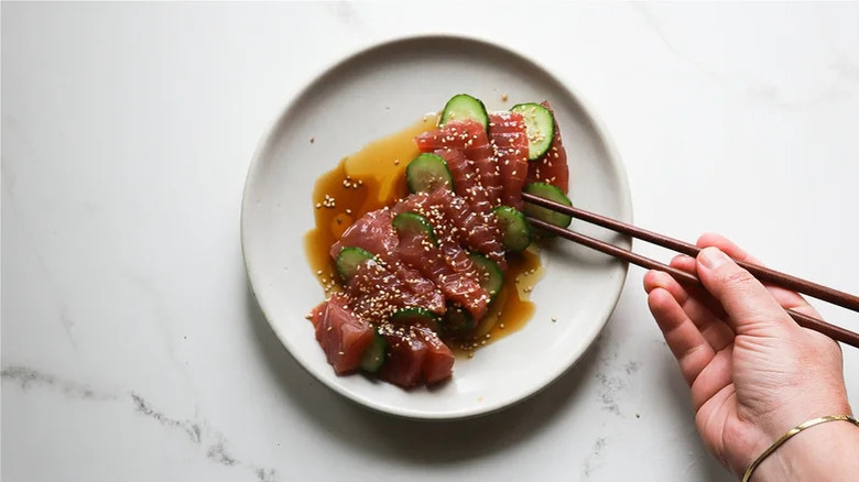 chopsticks with plated tuna crudo 