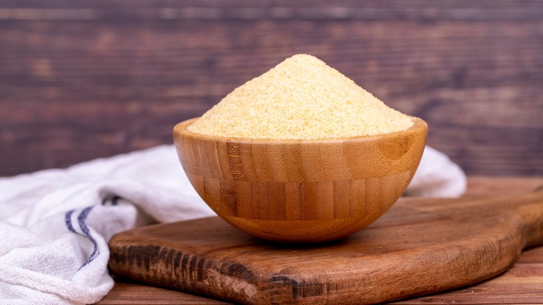 Wooden bowl of raw durum semolina wheat flour