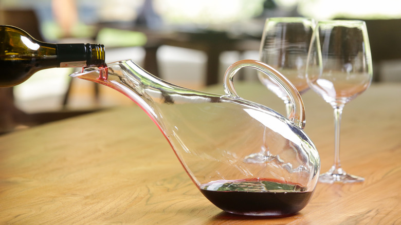 pouring wine into a decanter