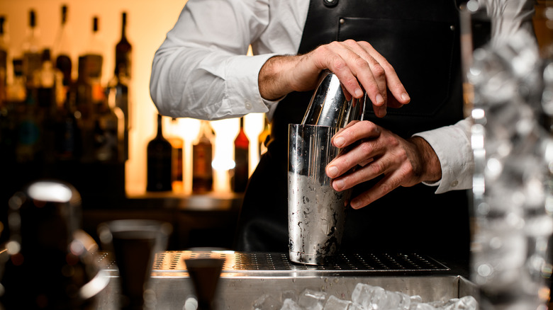 Hands using a cocktail shaker