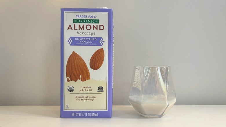 Box and glass of Trader Joe's Organic Unsweetened Vanilla Almond Beverage on white background