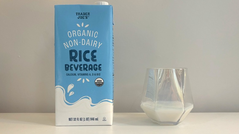 Box and glass of Trader Joe's Organic Non-Dairy Rice Beverage on white background