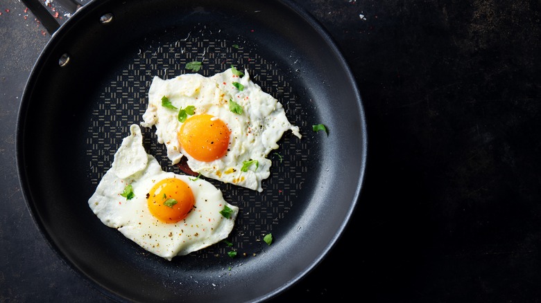 fried eggs in iron pan