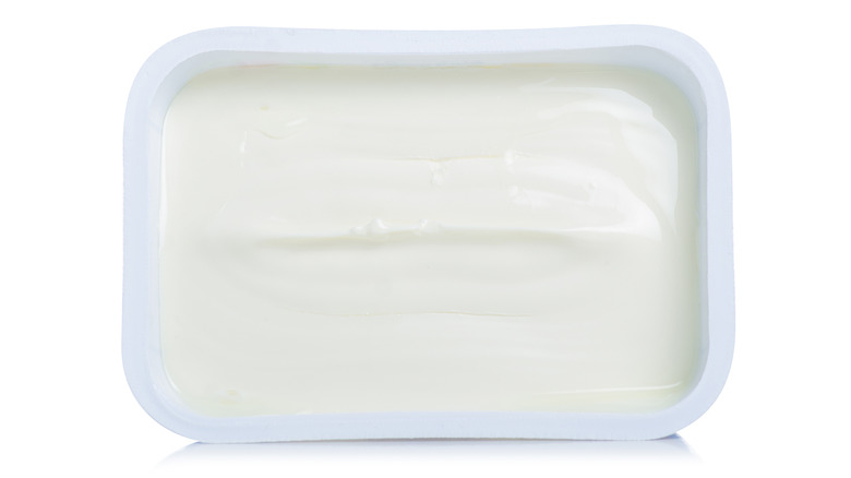 Open tub of cream cheese