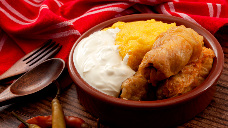 Romanian sarmale with polenta and sour cream