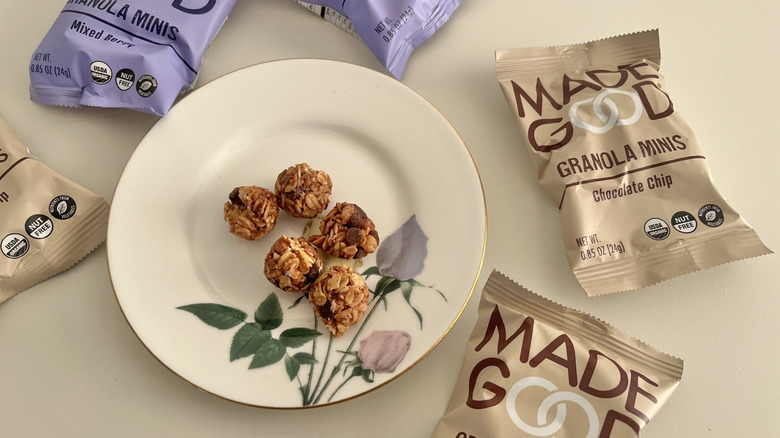 Chocolate chip MadeGood Granola Minis on a plate surrounded by Made Good packages