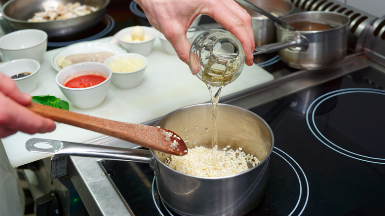 adding white wine to pot