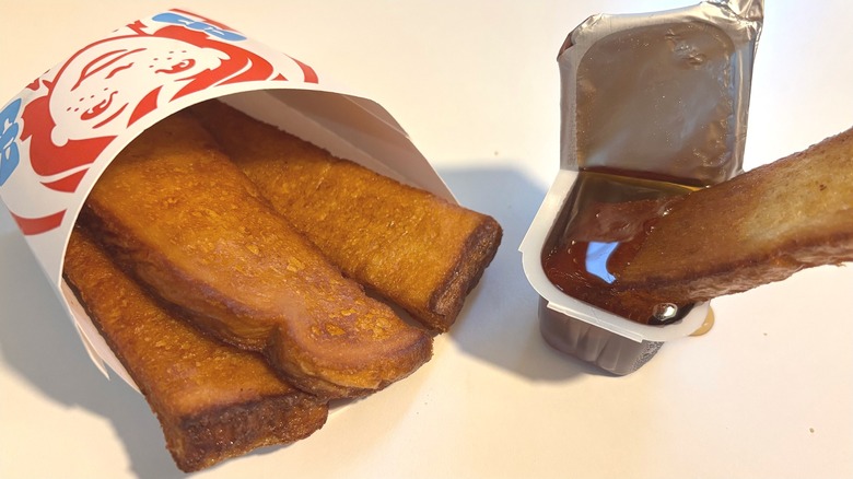 Wendy's French Toast Sticks and maple syrup on white table