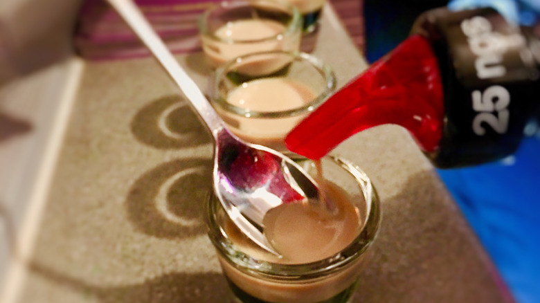 making baby guinness with spoon