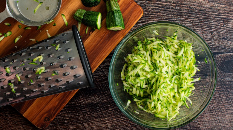 Grated zucchini in mixing bowl 