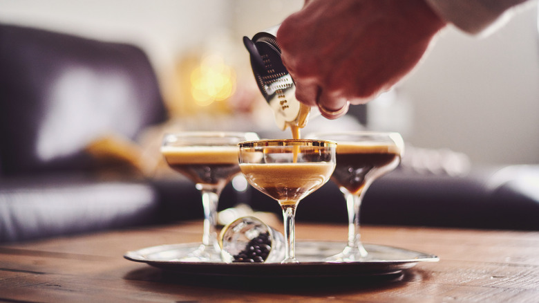 person pouring espresso martini