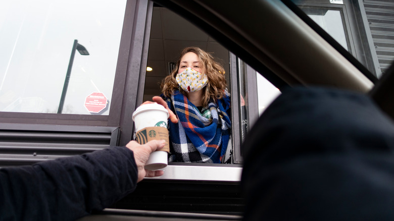 Barista at Starbucks drive-thru window