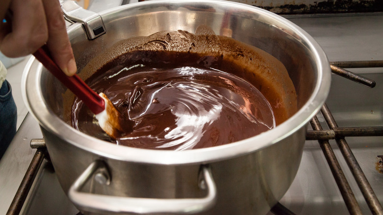 hand stirring liquid chocolate