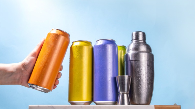 Canned beverages next to cocktail shaker