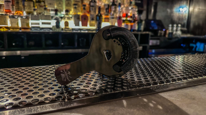 cocktail strainer sitting on a bar