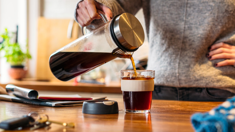 pouring homemade cold brew into glass