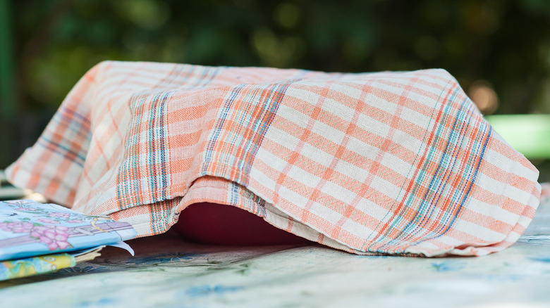 Bowl covered with kitchen towel