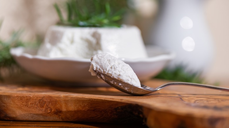 spoonful of ricotta on wooden board