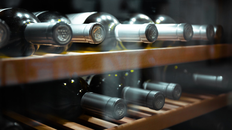 wine bottles lying in fridge