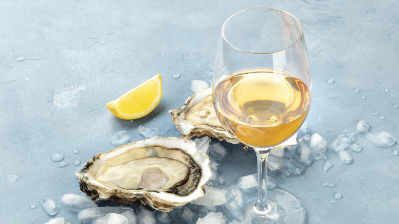 white wine glass with oyster