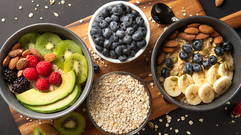 Top-down view of nuts, fruits, and oatmeal in bowls