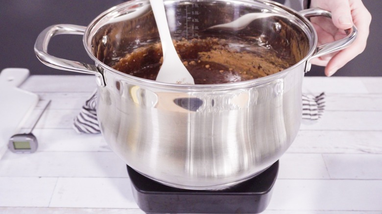 mixing ingredients in pot to make chocolate fudge