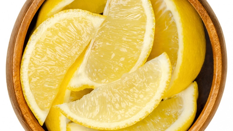 lemon wedges in a wooden bowl