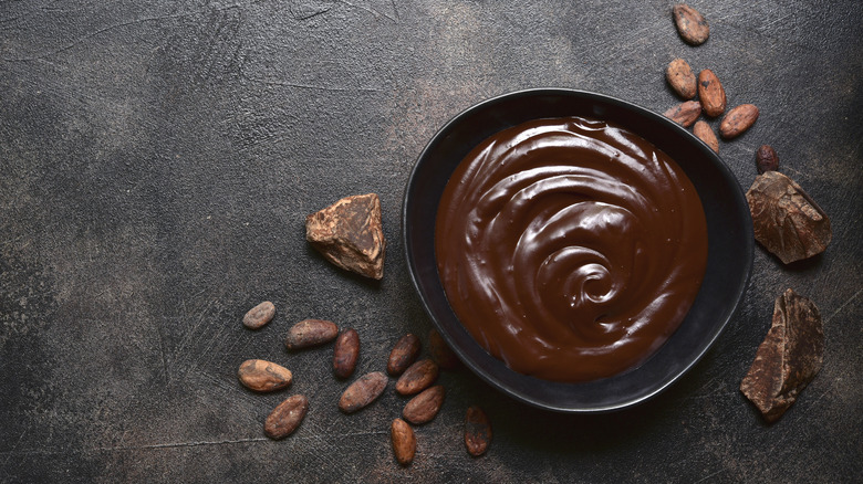 Bowl of ganache with chocolate pieces 