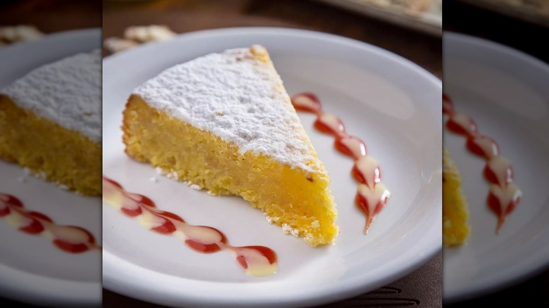 Slice of yellow cake on white plate 