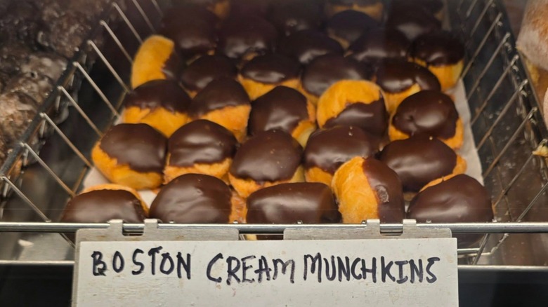 Basket of Boston Cream Munchkins labeled with handwritten sign