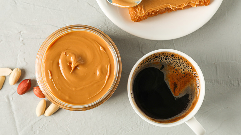 cup of coffee and peanut butter jar