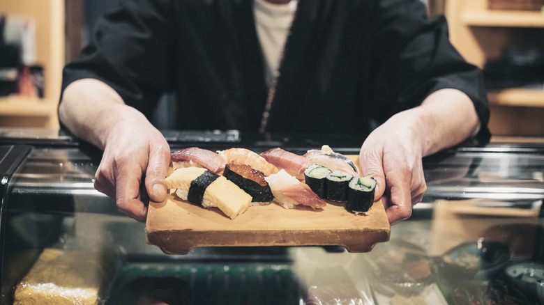 sushi chef at a counter