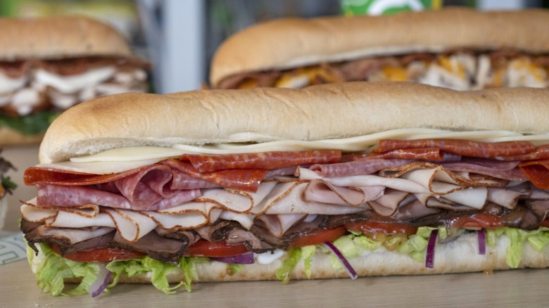 Three Subway meat sandwiches