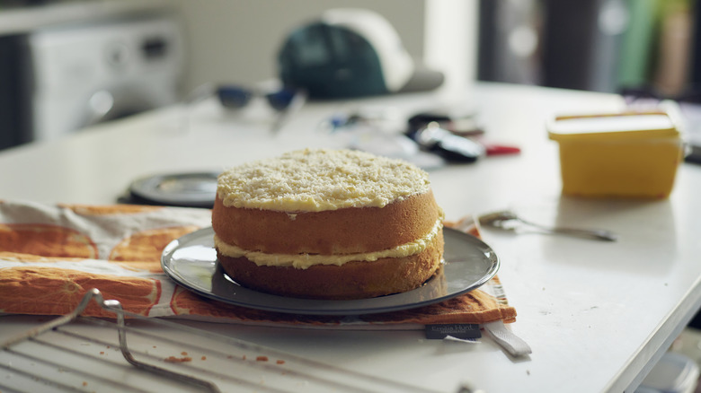 vanilla homemade cake on tray with white icing