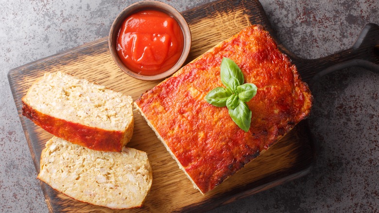 Sliced meatloaf on cutting board