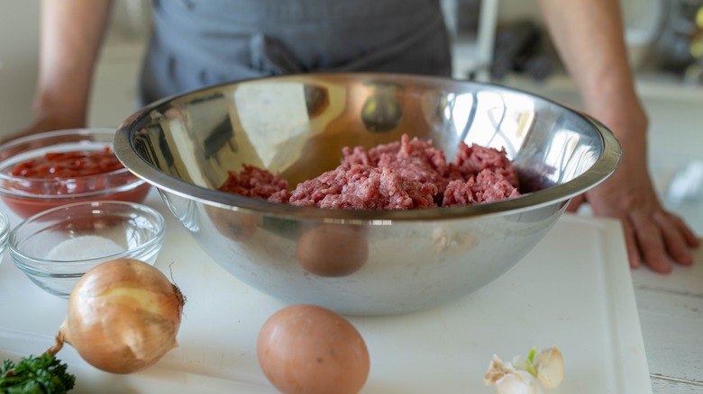 Mixing meatloaf ingredients