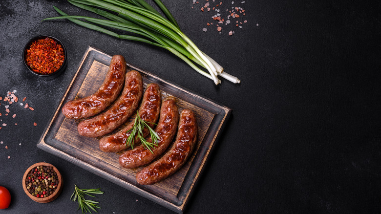 Top down view of cooked bratwursts on cutting board