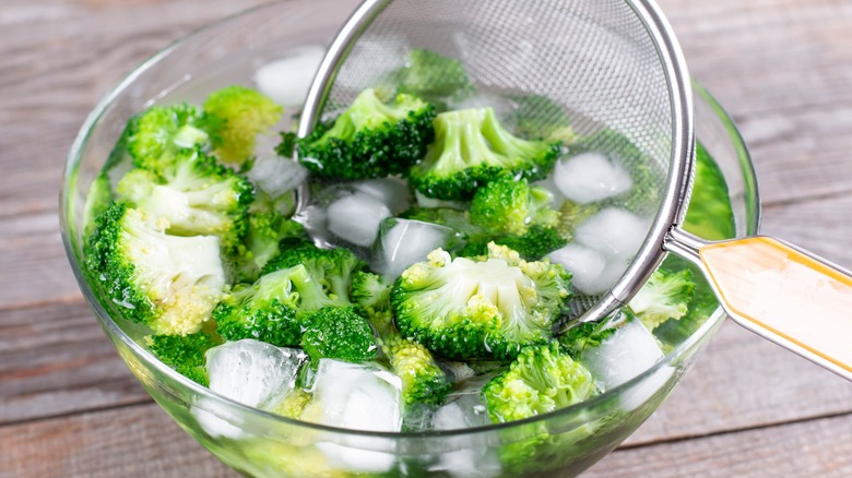 broccoli in ice water in a glass bowl