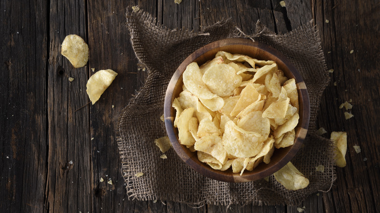 Potato chips in wooden bowl