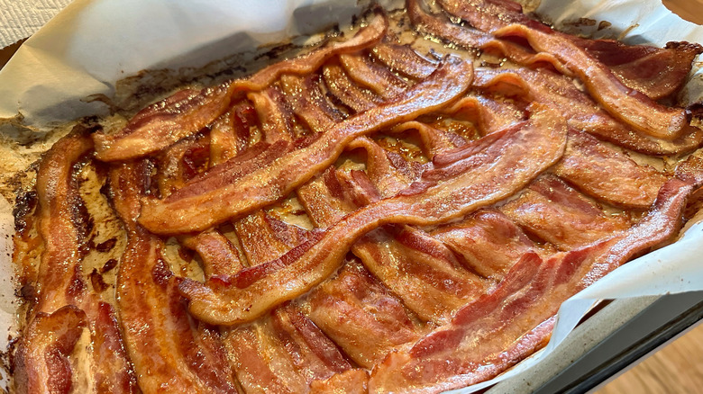 bacon cooking on a sheet pan