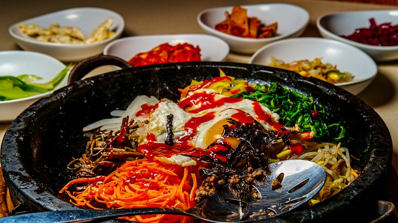 Bibimbap and banchan served on a table