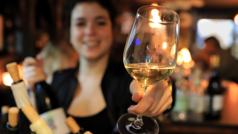 sommelier offering wine