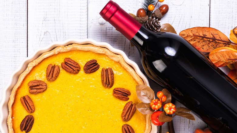 A pumpkin pie and a bottle of wine